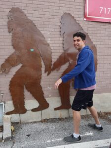 justin standing next to bigfoot